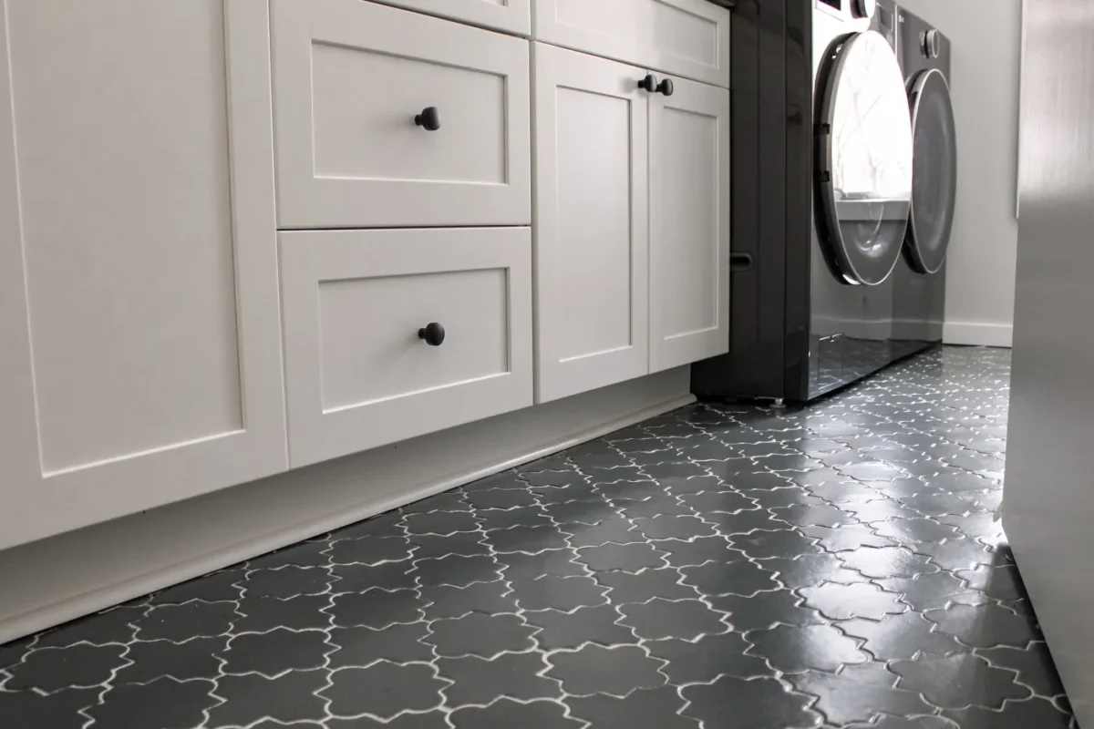 laundryroomremodelcustomcabinetryblackhardwarewashanddryertileflooring Element Design Build Remodel